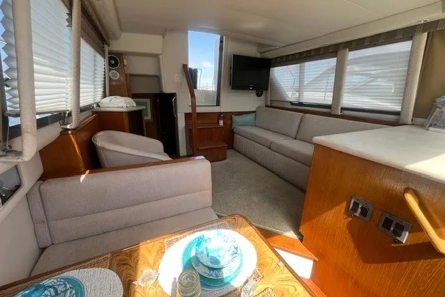 Slide: The Image of Interior of 1995 Carver 355 Aft Cabin Motor Yacht with cozy seating and dining area. - 14