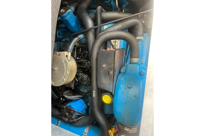 Slide: The Image of Engine components of a 1995 Carver 355 Aft Cabin Motor Yacht, featuring blue and black parts. - 26