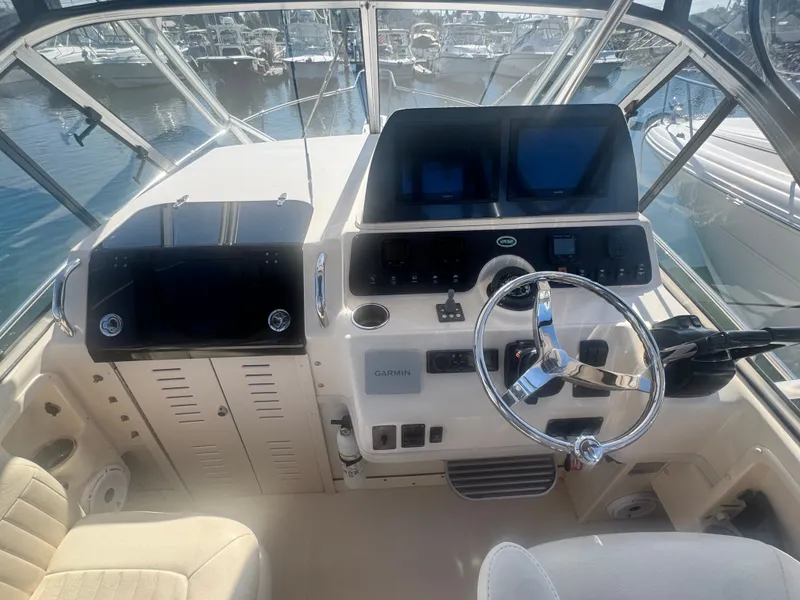 Slide: The Image of The cockpit of a 2006 Grady-White Sailfish 282 with modern electronics and comfortable seating. - 9