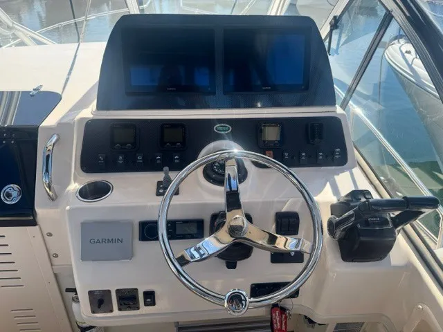 Slide: The Image of The image shows the helm of a 2006 Grady-White Sailfish 282 with modern instruments. - 10