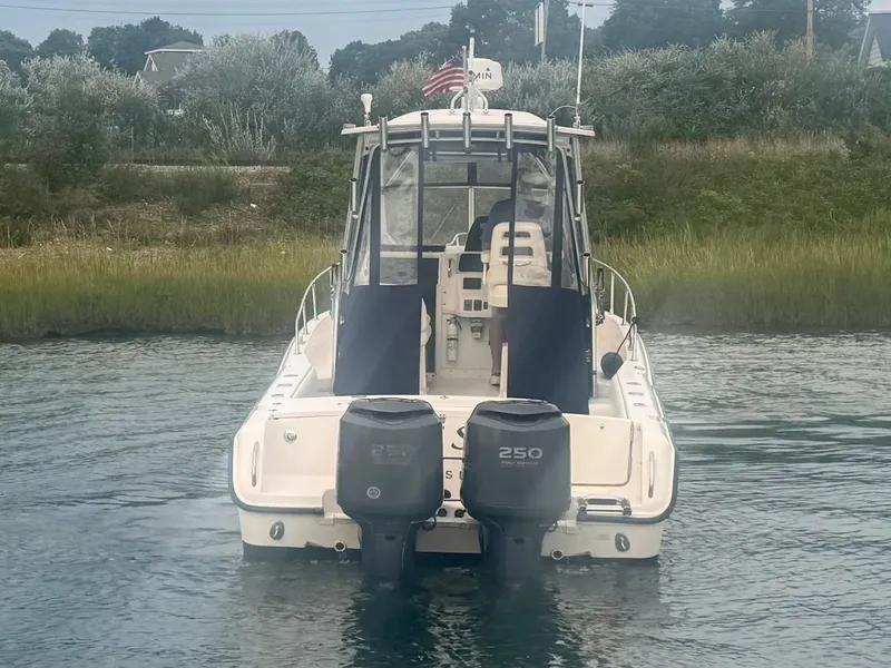 Slide: The Image of A 2006 Grady-White Sailfish 282 with twin outboard engines on calm water. - 8