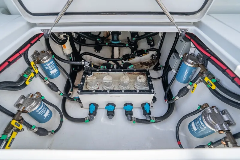 Slide: The Image of Engine compartment of 2024 Contender 44 ST boat, showcasing fuel filters and hoses. - 40