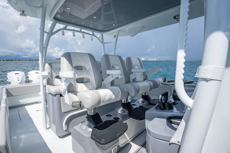 Slide: The Image of 2024 Contender 44 ST boat interior with luxurious seating and ocean backdrop. - 26