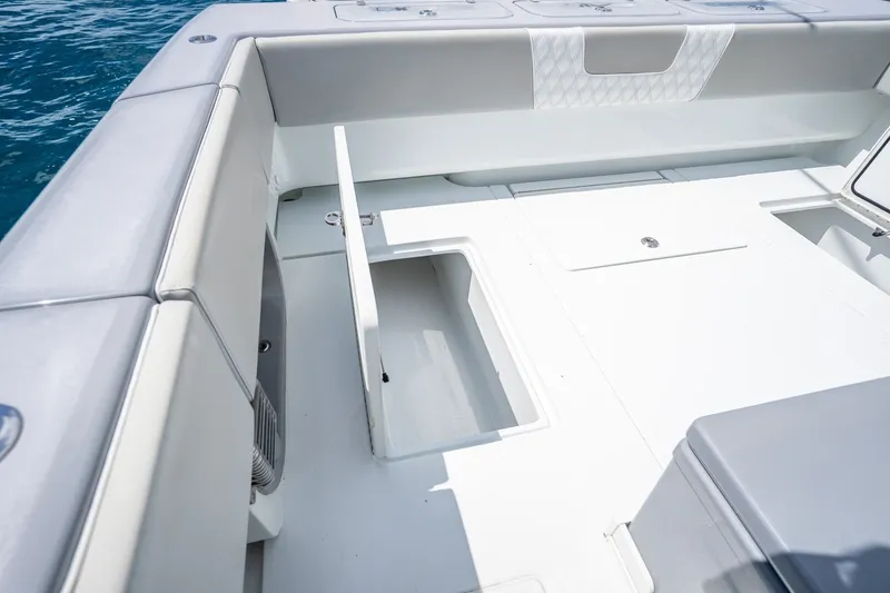 Slide: The Image of 2024 Contender 44 ST boat interior with open storage compartment on deck. - 16