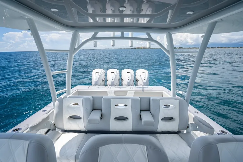 Slide: The Image of 2024 Contender 44 ST boat interior with luxurious seating and powerful engines on open water. - 21