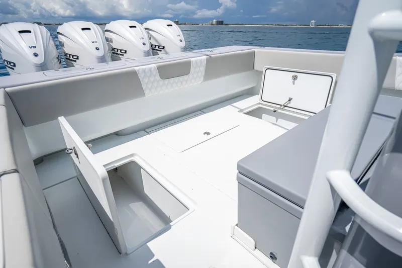 Slide: The Image of 2024 Contender 44 ST boat deck with storage compartments and powerful outboard engines. - 15