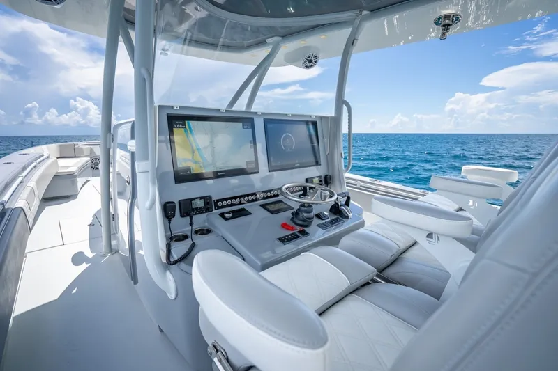 Slide: The Image of 2024 Contender 44 ST boat cockpit with advanced navigation system on open sea. - 23