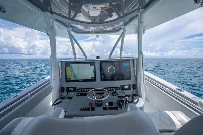 Slide: The Image of 2024 Contender 44 ST boat cockpit with advanced navigation system on open sea. - 24