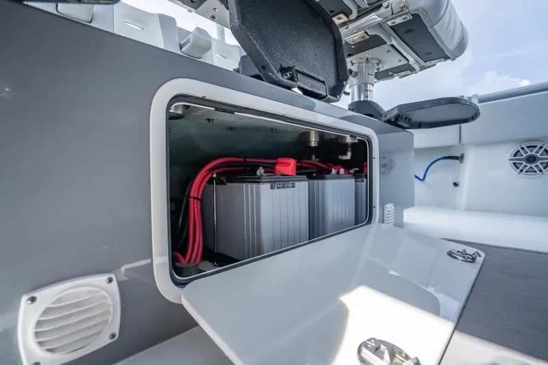 Slide: The Image of 2024 Contender 44 ST boat battery compartment with red cables and open hatch. - 32