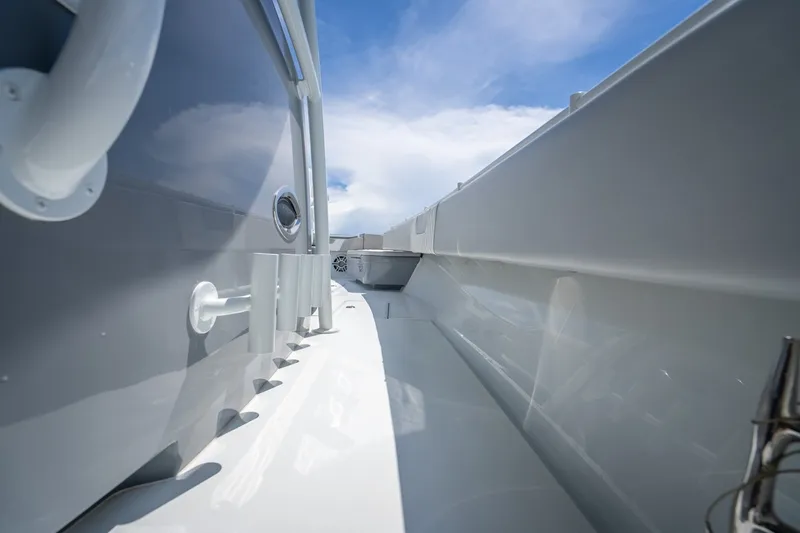 Slide: The Image of 2024 Contender 44 ST boat deck with sleek design under blue sky. - 31