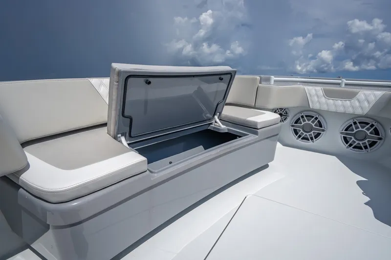 Slide: The Image of 2024 Contender 44 ST boat interior with open storage compartment and cushioned seating. - 37