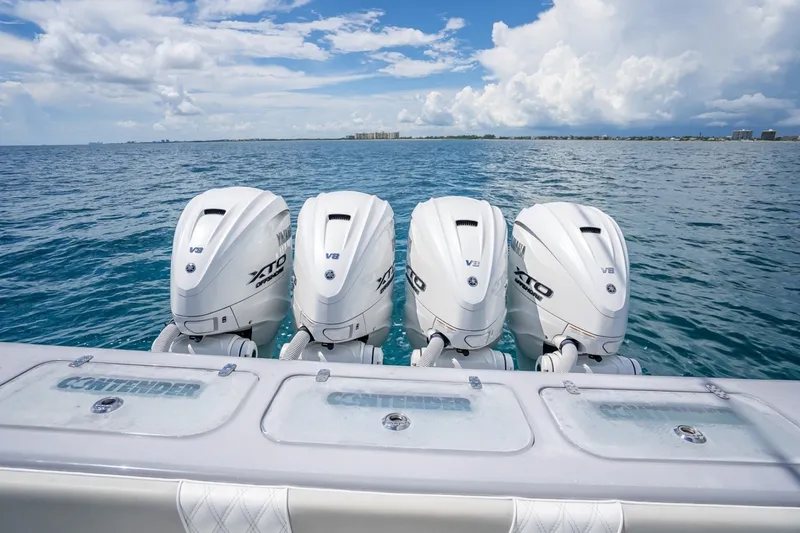 Slide: The Image of 2024 Contender 44 ST boat with four powerful V8 outboard engines on open water. - 14