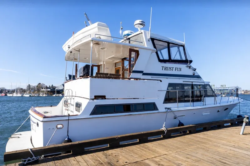 The Image of 1991 Lien Hwa Motor Yacht docked, named "Trust Fun," under clear blue sky. - 0