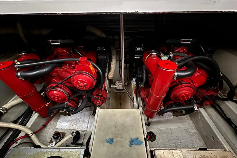 Slide: The Image of Engine compartment of a 1992 Tiara Sport 270 Sport boat, featuring dual red engines. - 23
