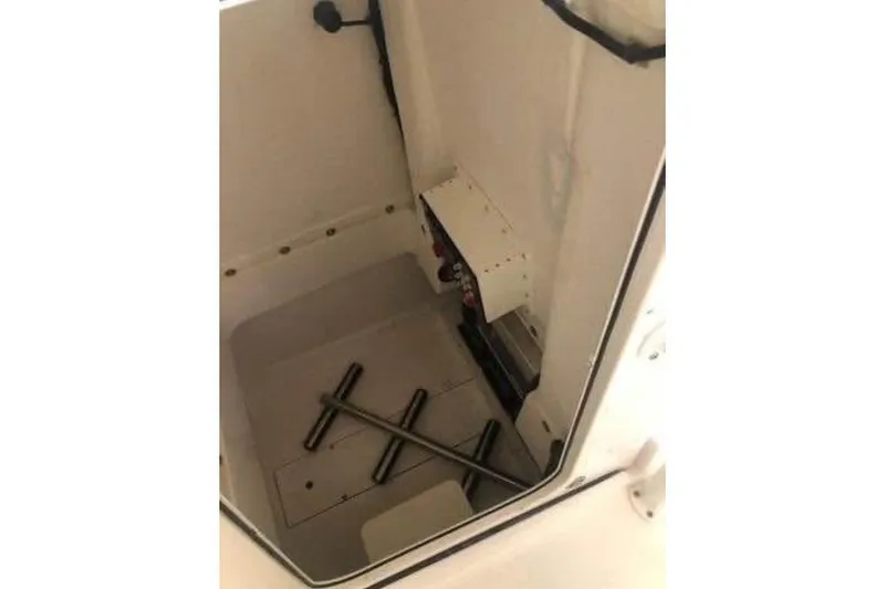 Slide: The Image of Interior view of 2021 Aquasport 2500 Center Console storage compartment. - 16