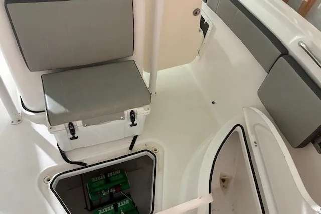 Slide: The Image of 2021 Aquasport 2500 Center Console interior with seating and storage compartments. - 32