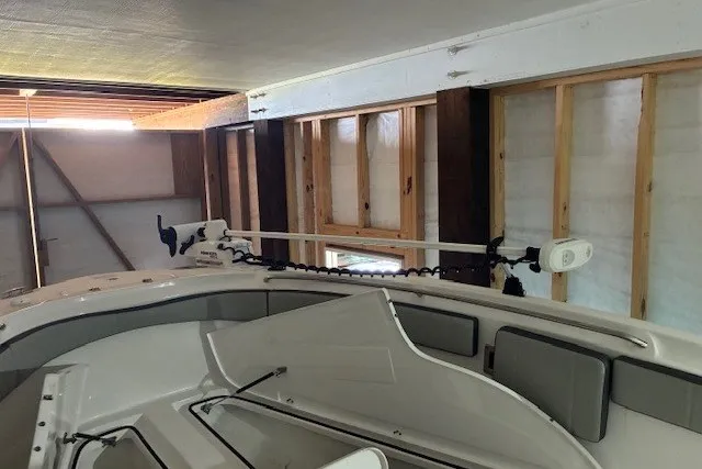 Slide: The Image of 2021 Aquasport 2500 Center Console boat in a wooden garage. - 30