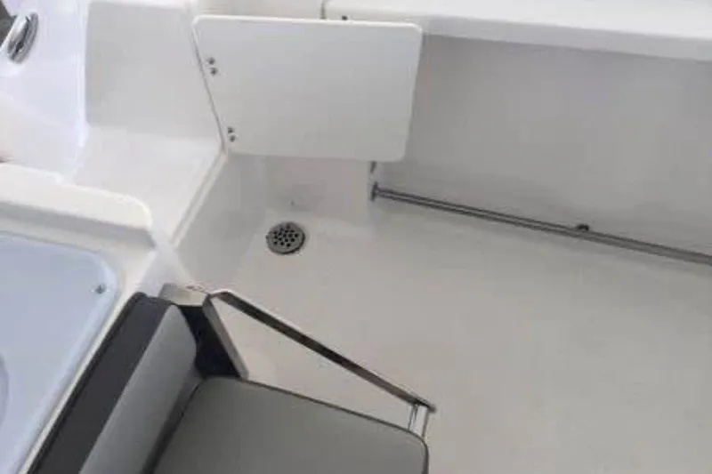 Slide: The Image of 2021 Aquasport 2500 Center Console interior with seating and drainage. - 11
