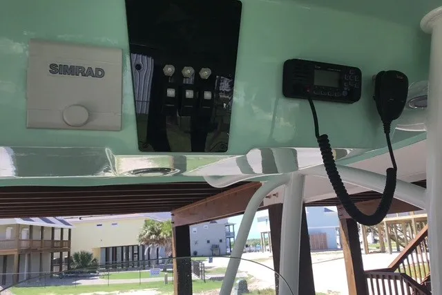 Slide: The Image of 2021 Aquasport 2500 Center Console dashboard with Simrad electronics and communication equipment. - 20
