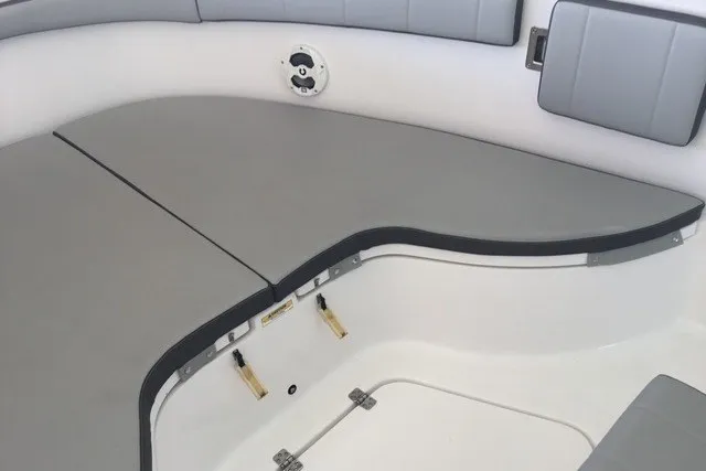 Slide: The Image of 2021 Aquasport 2500 Center Console boat interior with cushioned seating and storage. - 6