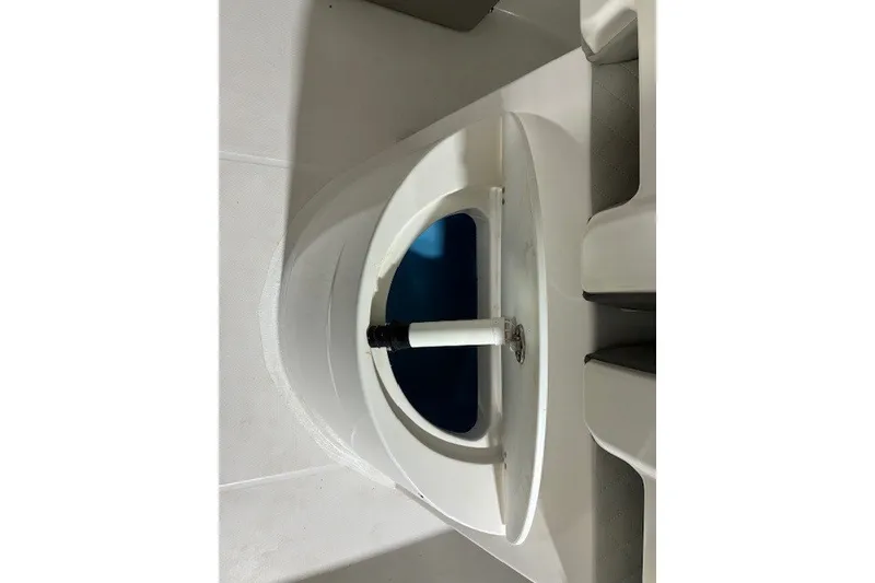 Slide: The Image of Livewell on 2021 Aquasport 2500 Center Console boat, featuring white interior. - 15