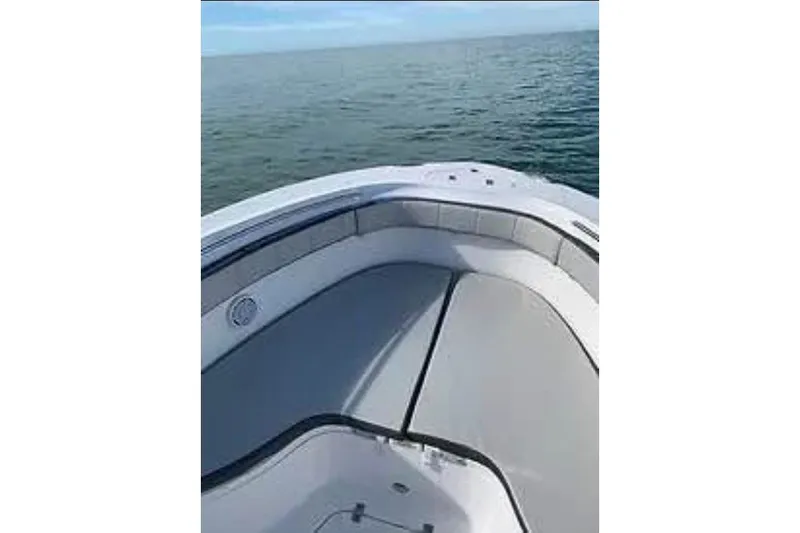 Slide: The Image of 2021 Aquasport 2500 Center Console boat on calm ocean waters. - 8