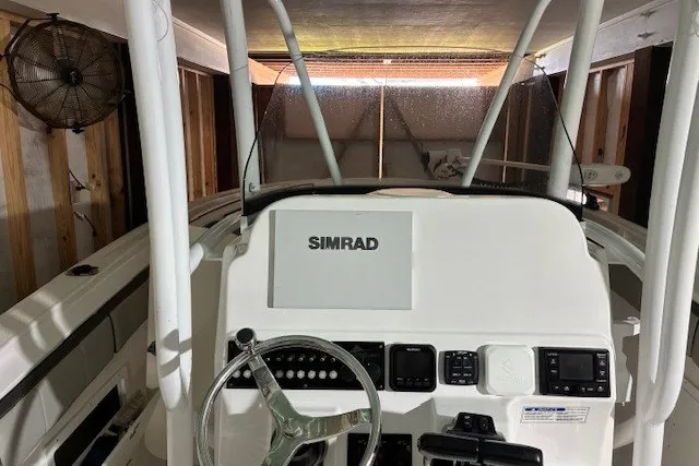 Slide: The Image of 2021 Aquasport 2500 Center Console boat dashboard with Simrad navigation system. - 29