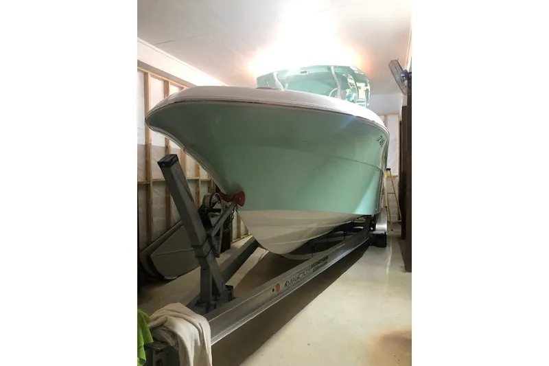 Slide: The Image of 2021 Aquasport 2500 Center Console boat on trailer in garage. - 1