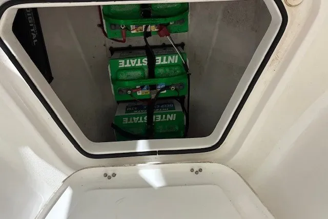 Slide: The Image of Batteries inside 2021 Aquasport 2500 Center Console boat compartment. - 19