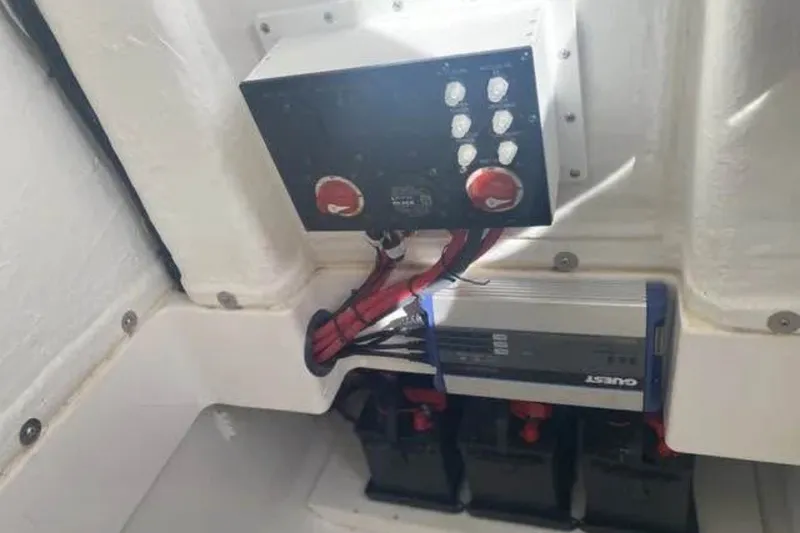 Slide: The Image of Electrical panel and battery setup in 2021 Aquasport 2500 Center Console boat. - 18