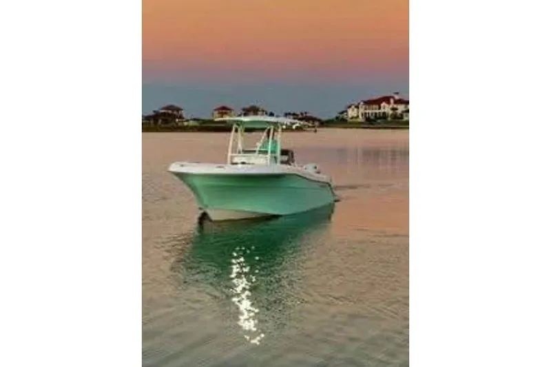The Image of 2021 Aquasport 2500 Center Console boat on calm water at sunset. - 0
