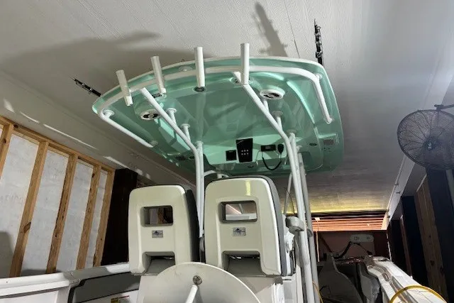 Slide: The Image of 2021 Aquasport 2500 Center Console boat with dual seats and overhead rod holders. - 26