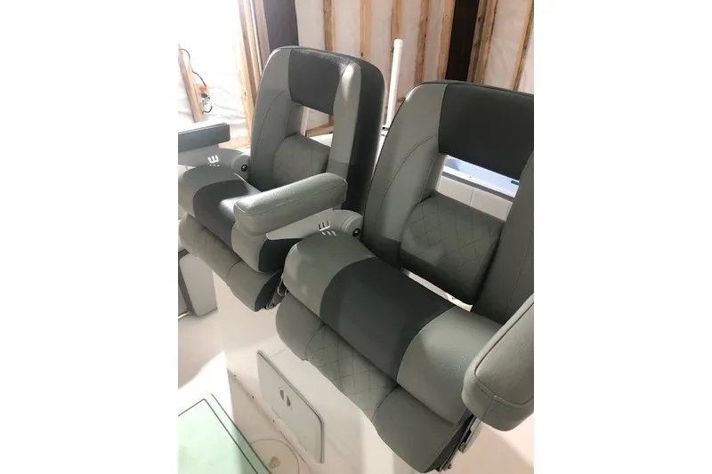Slide: The Image of 2021 Aquasport 2500 Center Console boat seats, featuring gray and black cushioned design. - 24