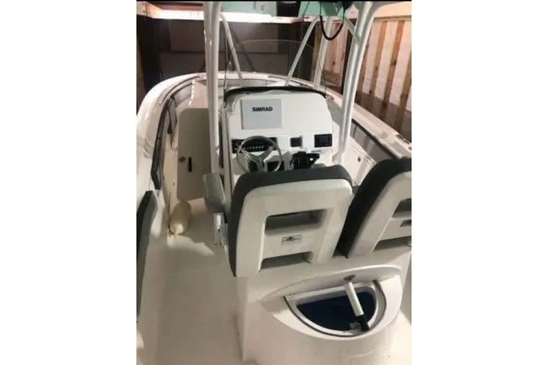 Slide: The Image of 2021 Aquasport 2500 Center Console boat interior with steering and seating. - 21