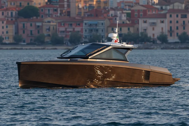 Slide: The Image of 2027 Wally wallypower50 yacht cruising near colorful coastal buildings. - 12