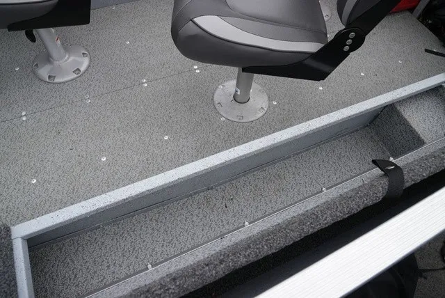 Slide: The Image of Interior view of a Lund 1600 Fury SS boat with gray flooring and swivel seats. - 11