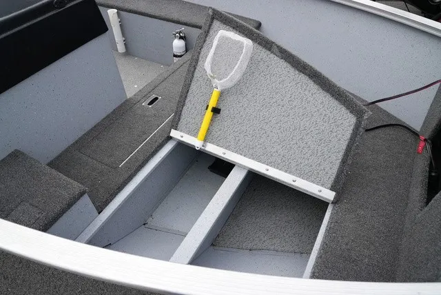 Slide: The Image of The image shows the interior of a 2023 Lund 1600 Fury SS boat with gray carpeting. - 7