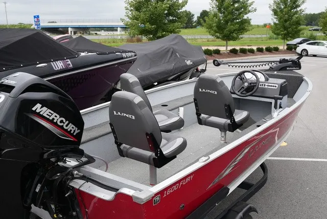 Slide: The Image of A red Lund 1600 Fury SS boat with gray seats and a Mercury engine. - 4