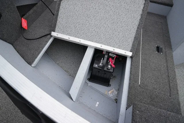 Slide: The Image of The image shows the interior of a 2023 Lund 1600 Fury SS boat with gray carpeting. - 9