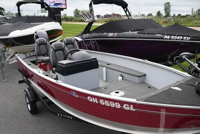 Slide: The Image of A 2023 Lund 1600 Fury SS boat with a red hull and gray interior, on a trailer. - 5