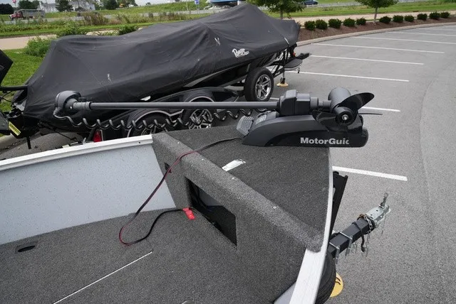 Slide: The Image of A 2023 Lund 1600 Fury SS with a MotorGuide motor on a trailer in a parking lot. - 8