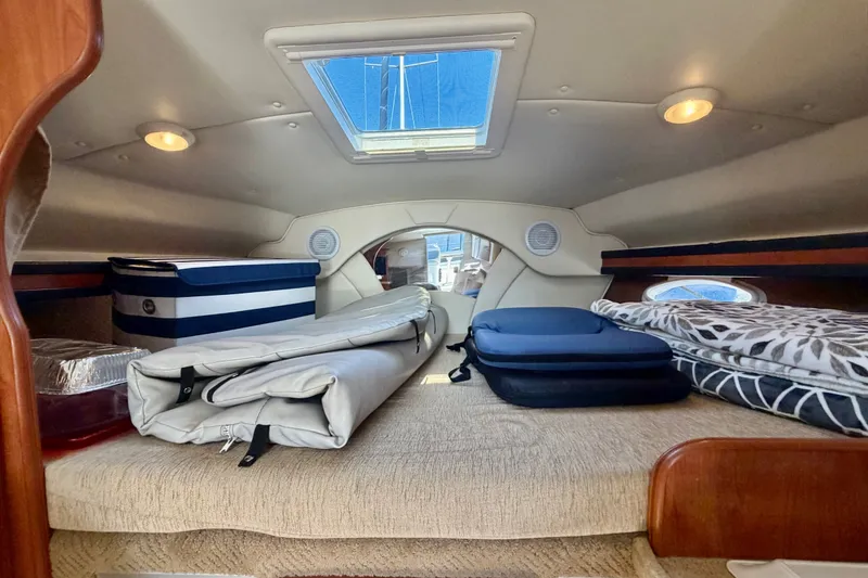 Slide: The Image of Interior cabin of a 2006 Rinker 320 Express Cruiser with bedding and storage. - 50