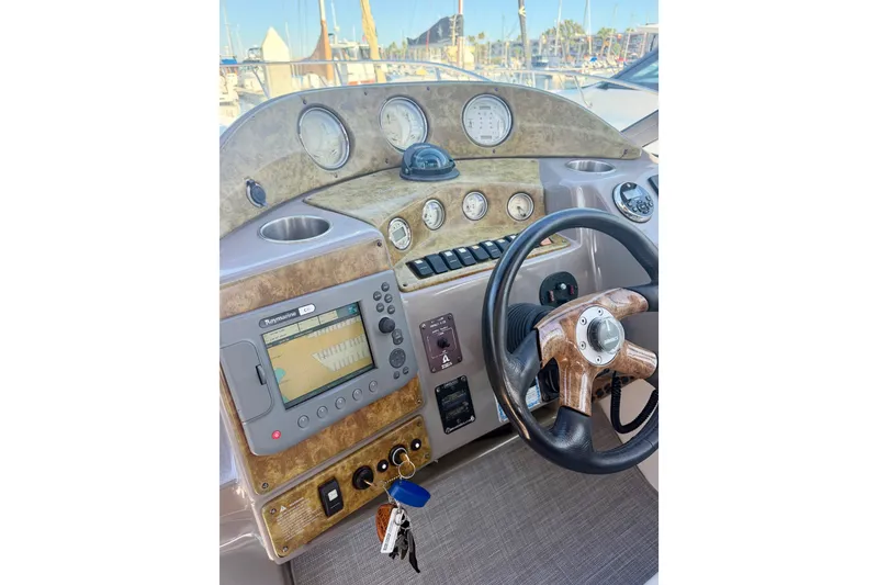 Slide: The Image of 2006 Rinker 320 Express Cruiser dashboard with steering wheel and navigation system. - 38