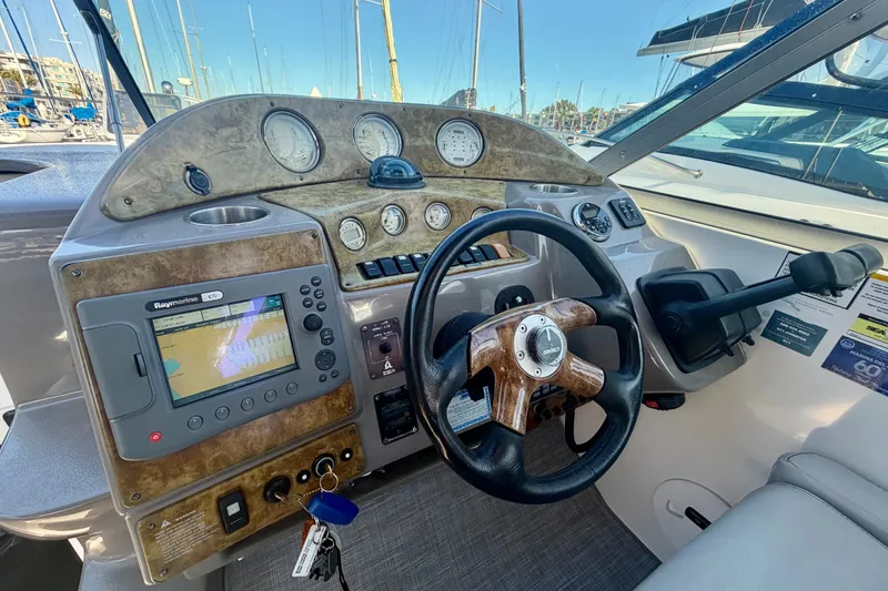 Slide: The Image of Cockpit of 2006 Rinker 320 Express Cruiser with navigation system and steering wheel. - 39