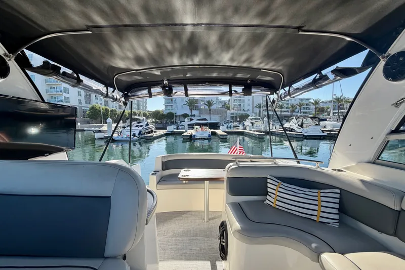 Slide: The Image of Interior view of a 2006 Rinker 320 Express Cruiser docked at a marina. - 22