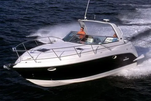 Slide: The Image of 2006 Rinker 320 Express Cruiser navigating on open water. - 58