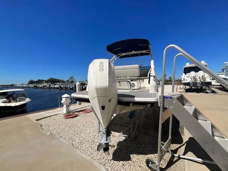 Slide: The Image of A 2021 Sea Ray SDX 250 Outboard is docked. The sky is clear and blue. - 22