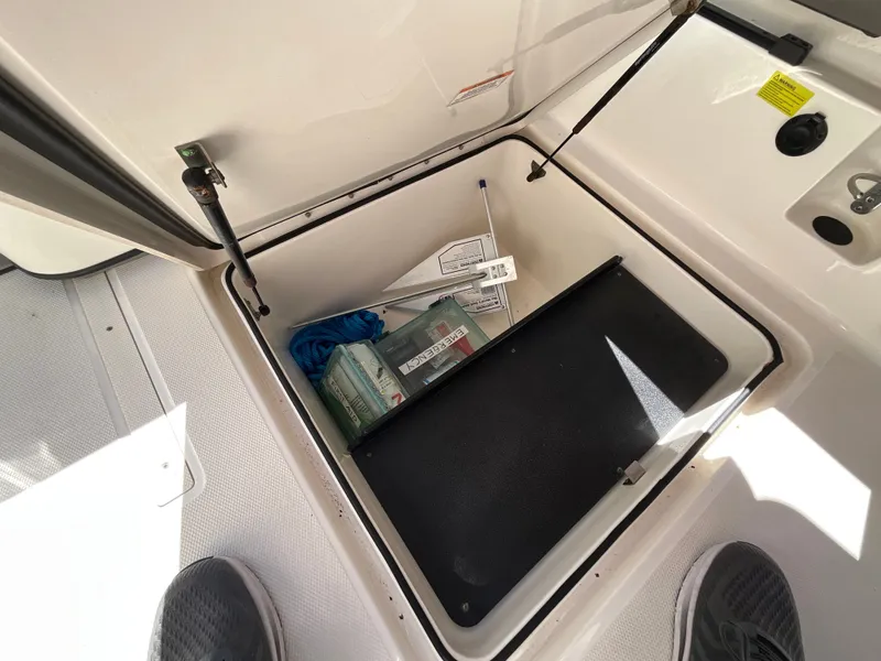 Slide: The Image of An open storage compartment on a boat with various items inside. - 6