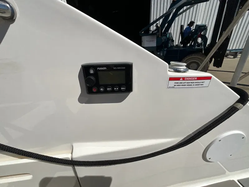 Slide: The Image of A Fusion marine audio system is mounted on the white interior wall of a 2021 Sea Ray SDX 250 Outboard. - 28