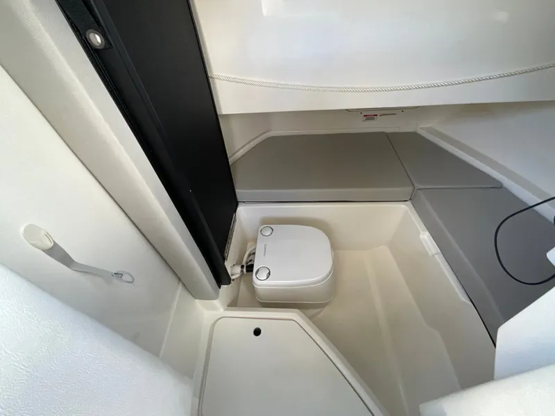 Slide: The Image of Interior of a 2021 Sea Ray SDX 250 Outboard featuring a toilet. - 5